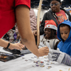 Photos of children and their families enjoying a holiday event that featured NASA astronauts and activities.