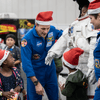 Photos of children and their families enjoying a holiday event that featured NASA astronauts and activities.