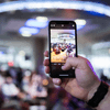 People gather together around a television in a cafeteria.