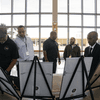 Photos of people in professional attire participating in a Black History Month program.