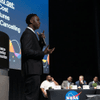 Students give a presentation on the stage in an auditorium. 