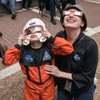 A crowd of people outside or in a lobby celebrating the 2024 eclipse in Texas. 