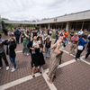 A crowd of people outside or in a lobby celebrating the 2024 eclipse in Texas. 