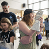 A crowd of people outside or in a lobby celebrating the 2024 eclipse in Texas. 