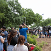 A crowd of people outside or in a lobby celebrating the 2024 eclipse in Texas. 