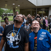 A crowd of people outside or in a lobby celebrating the 2024 eclipse in Texas. 
