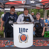 A group of people gather outside for a chili cook-off.