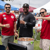 A group of people gather outside for a chili cook-off.