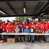 A group of people gather outside for a chili cook-off.