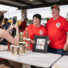 A group of people gather outside for a chili cook-off.