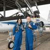 Two astronauts prepare to fly on T-38 jets.