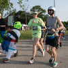 A group of people dressed in costumes outside during a race event.