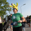 A group of people dressed in costumes outside during a race event.