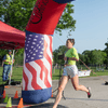 A group of people dressed in costumes outside during a race event.