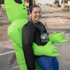 A group of people dressed in costumes outside during a race event.