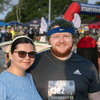 A group of people dressed in costumes outside during a race event.