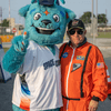 A group of people dressed in costumes outside during a race event.