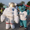 A group of people dressed in costumes outside during a race event.