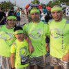 A group of people dressed in costumes outside during a race event.