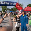 A group of people dressed in costumes outside during a race event.