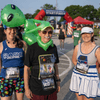 A group of people dressed in costumes outside during a race event.