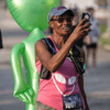 A group of people dressed in costumes outside during a race event.