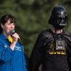 A group of people dressed in costumes outside during a race event.