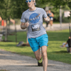 A group of people dressed in costumes outside during a race event.