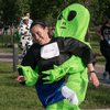 A group of people dressed in costumes outside during a race event.