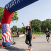 A group of people dressed in costumes outside during a race event.