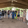 A group of people dressed in costumes outside during a race event.