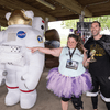 A group of people dressed in costumes outside during a race event.