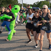 A group of people dressed in costumes outside during a race event.