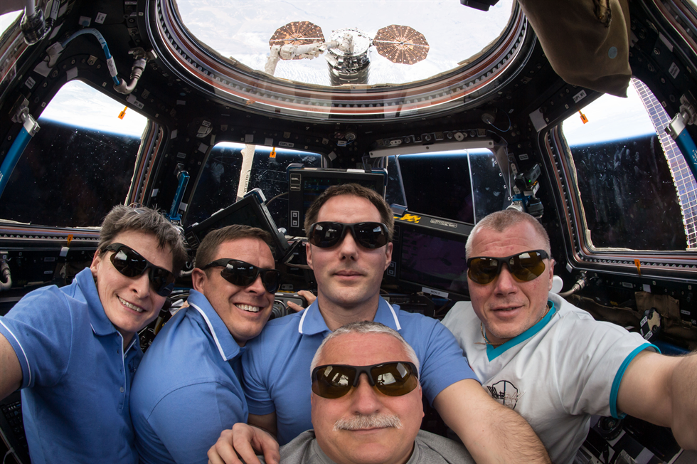 The five Expedition 51 crew members pose for a portrait with the captured Cygnus resupply ship from Orbital ATK just outside the cupola. In the foreground is Flight Engineer Fyodor Yurchikhin. In the background from left, are Commander Peggy Whitson and Flight Engineers Jack Fischer, Thomas Pesquet and Oleg Novitskiy. 