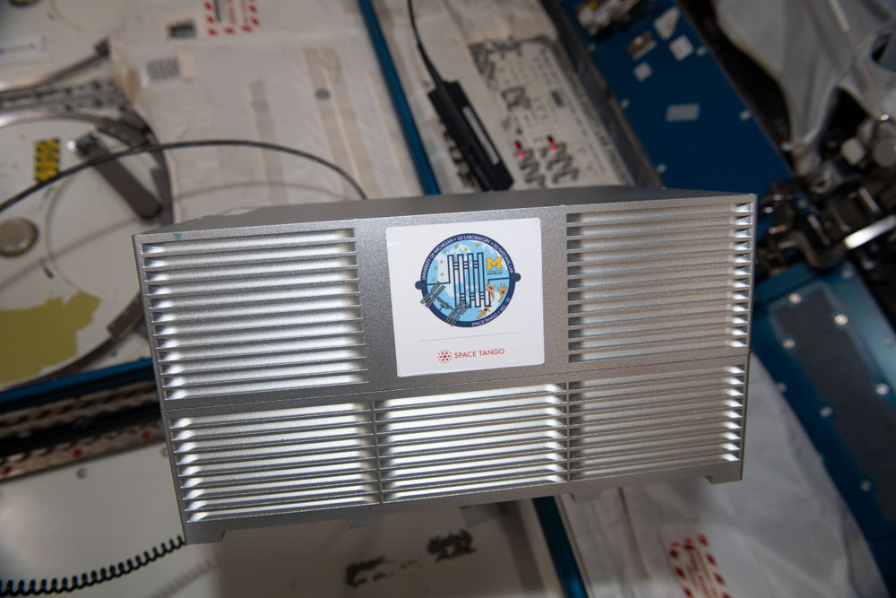 A view of a silver, rectangular box called the Cellular Mechanotransduction by Osteoblasts CubeLab aboard the International Space Station.