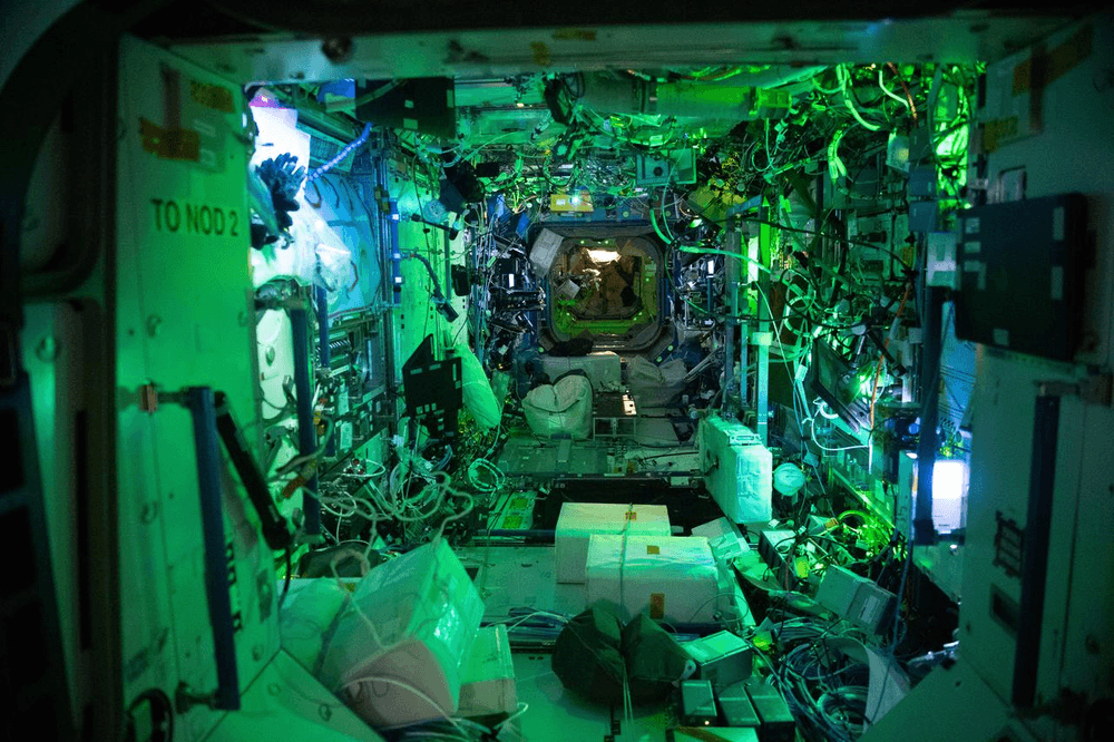 An interior view of the Destiny U.S. Laboratory at night under ambient light with the main lights turned off. The Destiny module supports a variety of life and physical sciences, technology demonstrations, and educational events. Credits: NASA