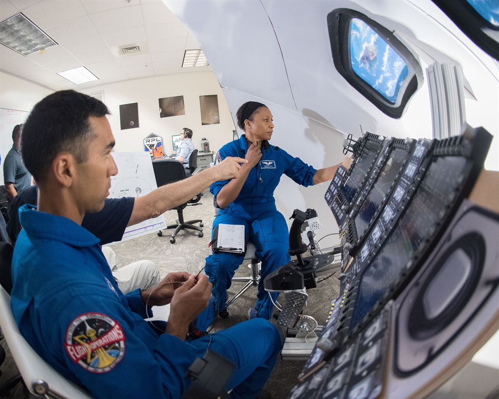 Views taken during a lunar trajectory burn mini-sim in Building 4 South. Astronauts Raja Chari and Jeanette Epps are visible during the simulation. Image Credit: NASA/Norah Moran