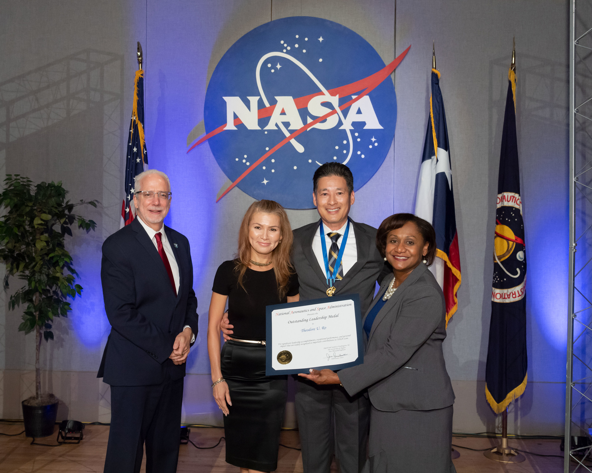 The success implementing daring changes to the legal office results in Ro receiving an Outstanding Leadership Medal from Johnson Center director Mark Geyer.