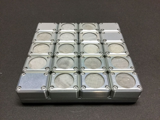 A pre-flight view of the Tanpopo exposure panel with its 20 small units containing radiation-resistant microbes, cyanobacteria, rice seeds, and dead cells of mosses and tree samples. Credits: Tanpopo-3 team