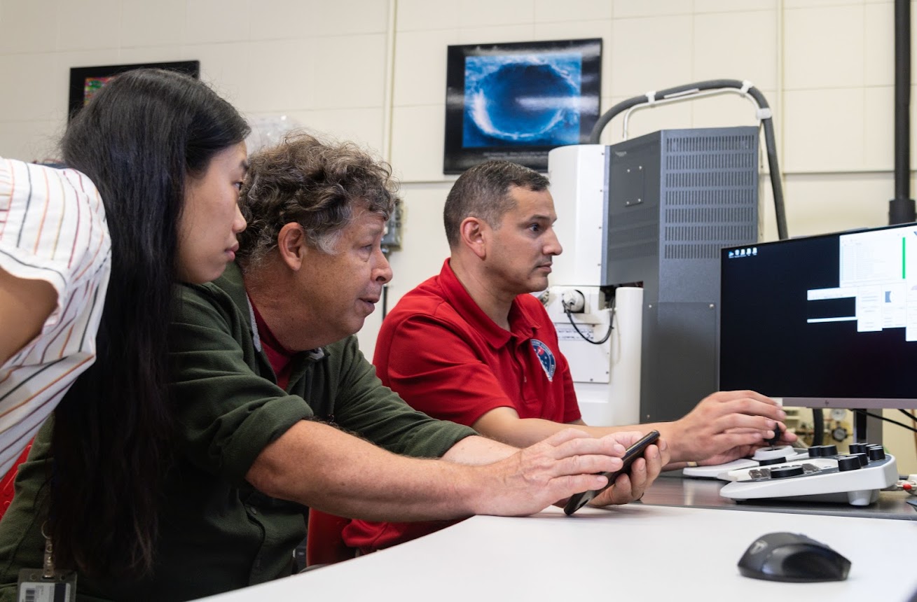 Mike Zolensky, middle, uses a scanning electron microscope to analyze asteroid Ryugu samples with James Martinez and JangMi Han. These samples, returned from the Japan Aerospace Exploration Agency Hayabusa-2 mission, are being studied at NASA’s Johnson Space Center. Credits: NASA/James Blair