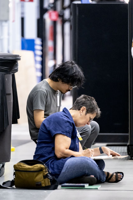 Two artists sketch at NASA