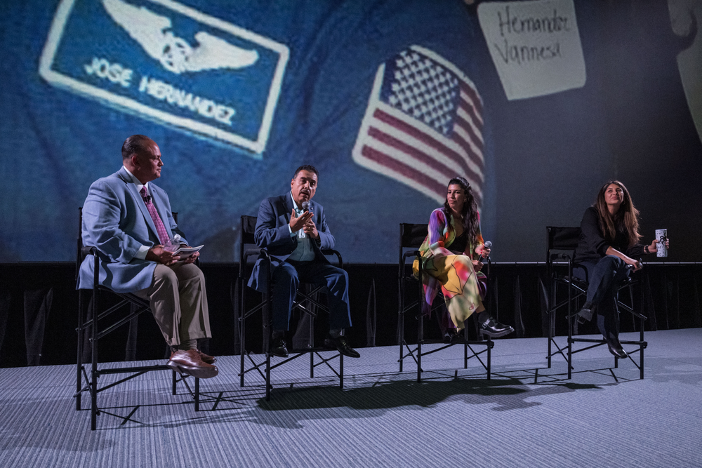 Four panelists joined in front of a theater screen to discuss the making of the "A Million Miles Away" movie.