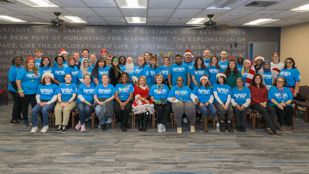 A group of people pose for a group photo.