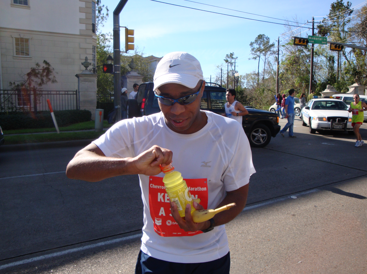 Keelan, an 11-time marathon runner, grabs a refreshment during the 2009 Houston Marathon. Image courtesy of Keelan Hamilton.