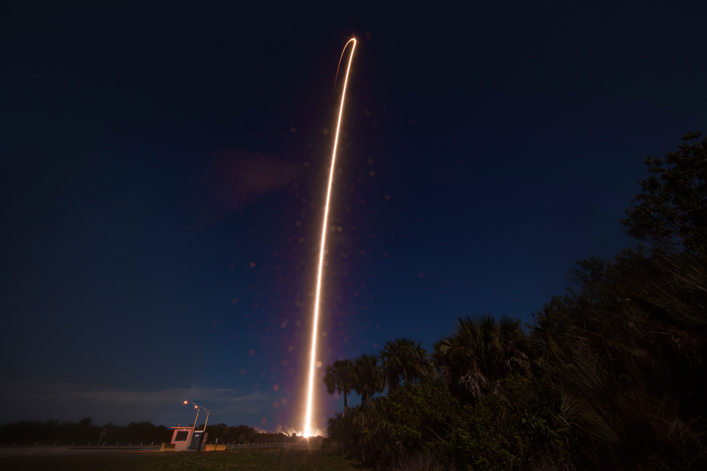 View of a rocket launching in the sky at night. 