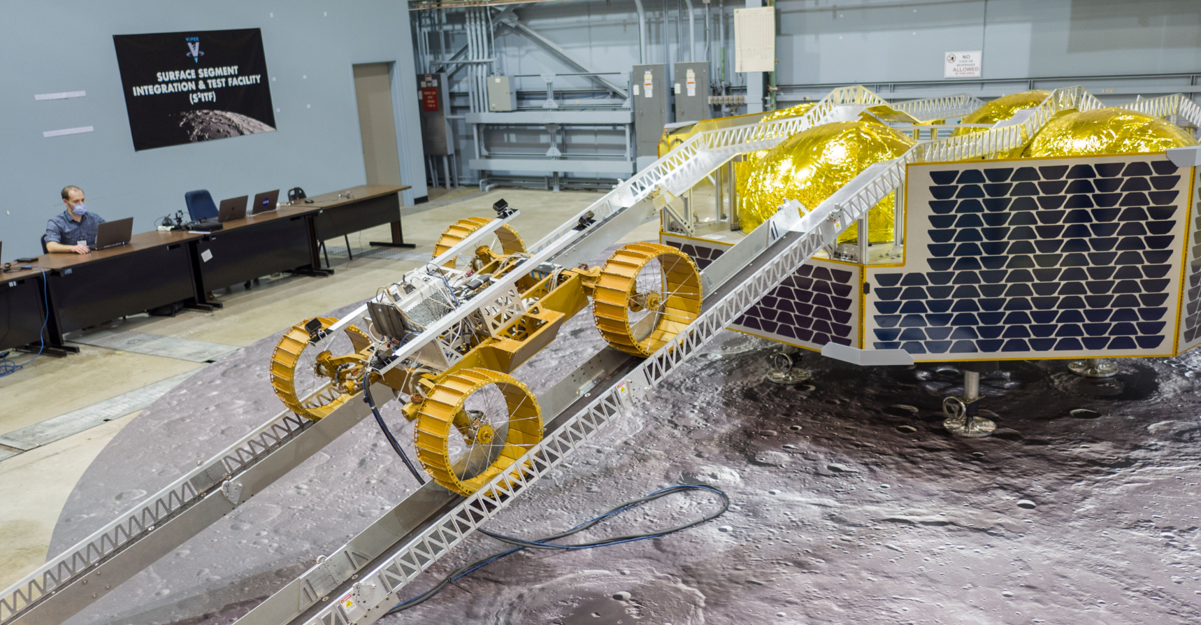 When NASA’s water-hunting robot – the Volatiles Investigating Polar Exploration Rover, or VIPER – arrives on the lunar surface, it will use two folding ramps to drive off the lander in style and begin exploring the Moon. About a year ago, the VIPER team tested those ramps at NASA’s Johnson Space Center in Houston. Credits: NASA/James Blair