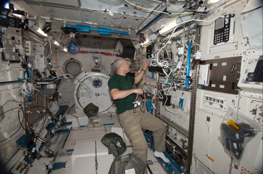 NASA astronaut Steve Swanson, Expedition 39 flight engineer, works with NanoRacks hardware in the Kibo laboratory of the Japan Aerospace Exploration Agency. Credits: NASA