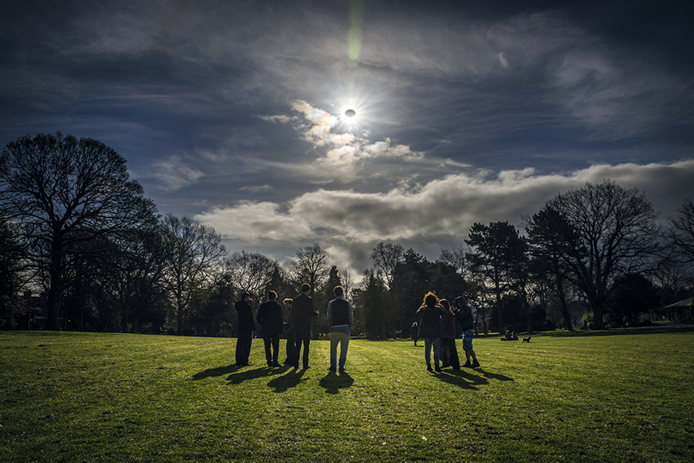 People watch a partial eclipse in Belfast, Northern Ireland, on March 20, 2015.