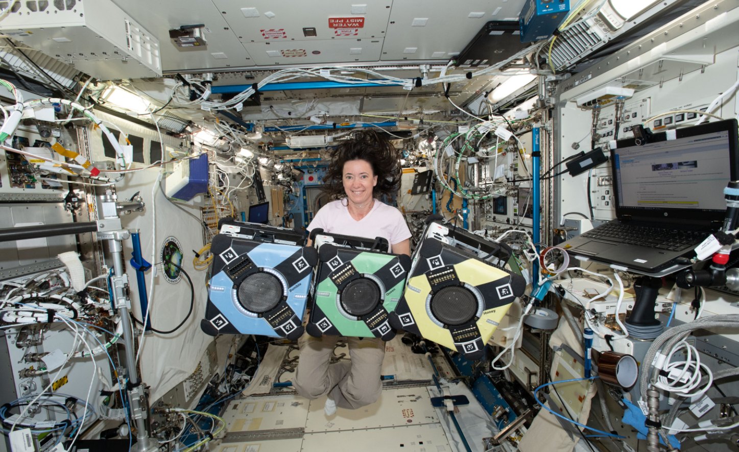 NASA astronaut Megan McArthur poses with the Astrobee robotic free-flyers in support of the Kibo Robot Programming Challenge, or Robo-Pro Challenge. Credits: NASA