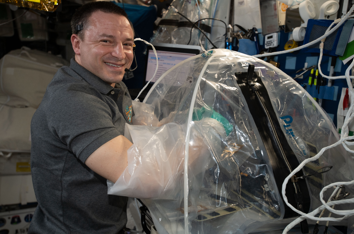 NASA astronaut and Expedition 62 Flight Engineer Andrew Morgan conducts cardiac research activities inside the portable glovebag. Credits: NASA